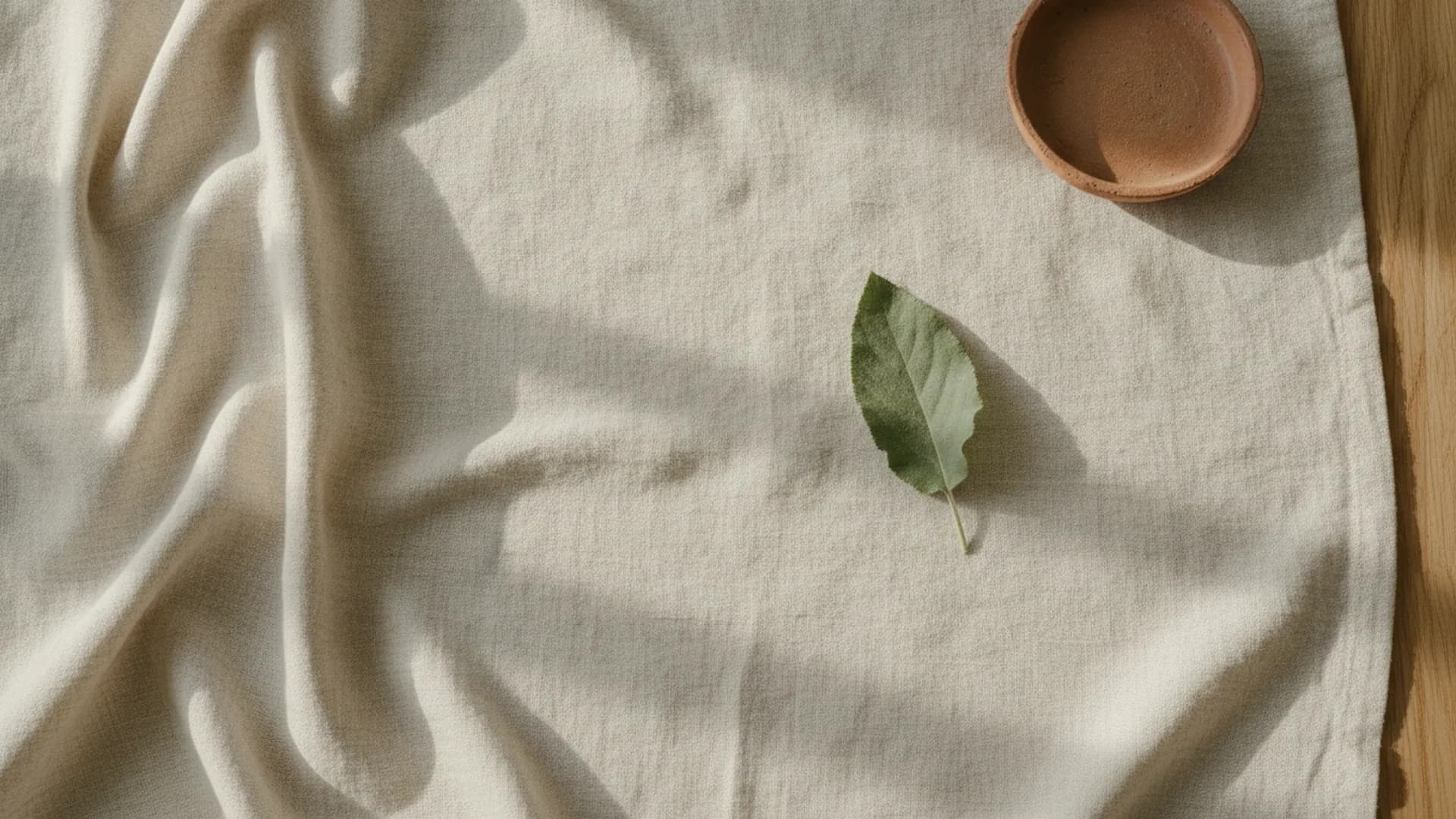 A calm, sunlit corner with natural linen and a plant